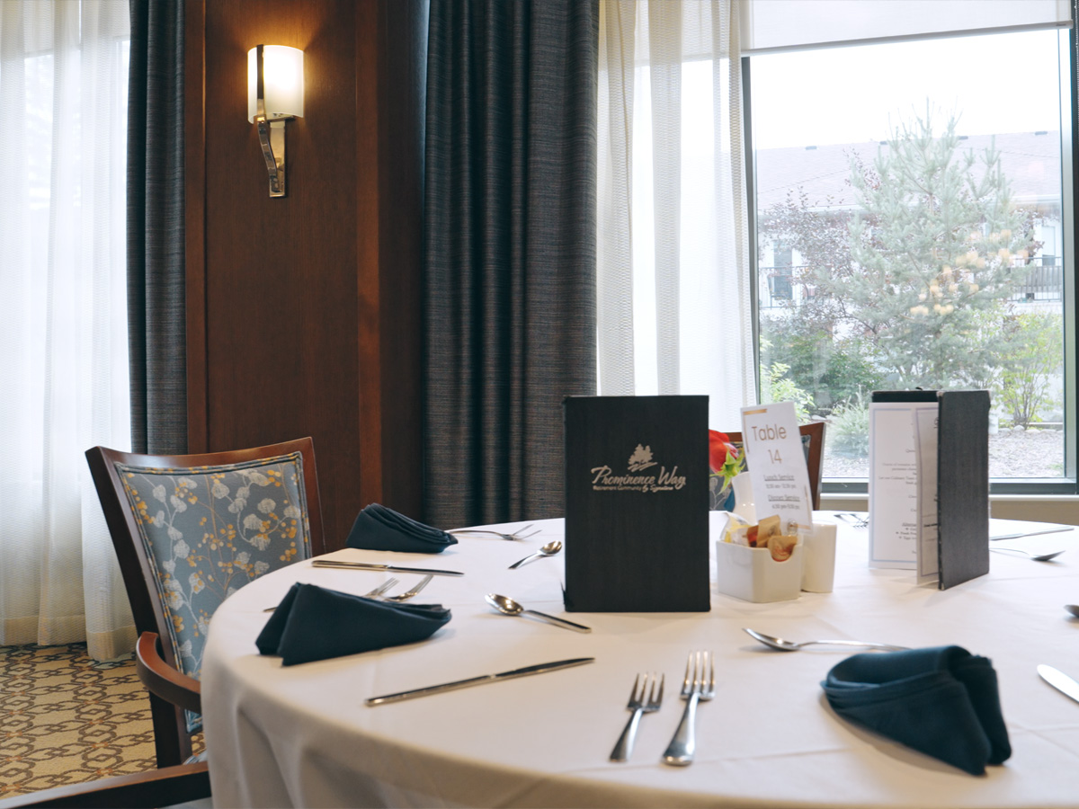 Set dining table with menus reading Prominence Way and a Table 14 card.